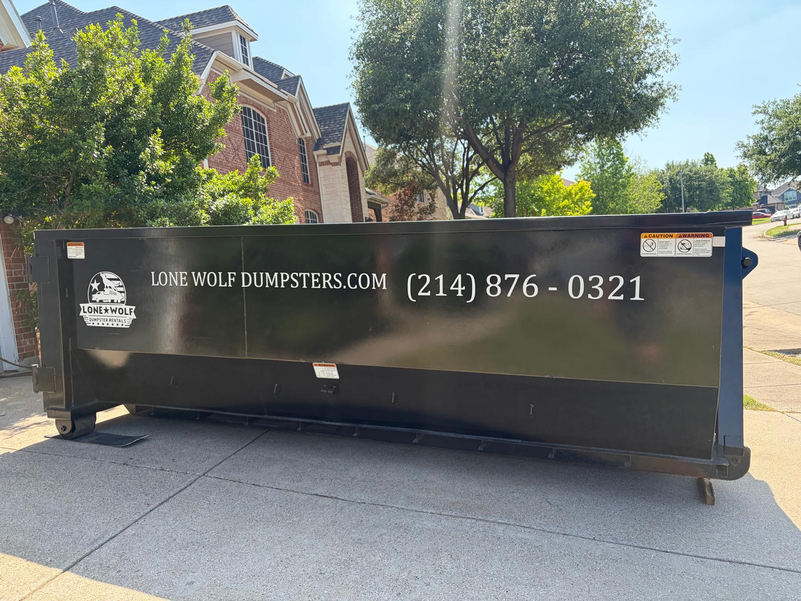 Lone Wolf Dumpsters roll-off truck ready for dumpster rental dispatch across Dallas-Fort Worth DFW