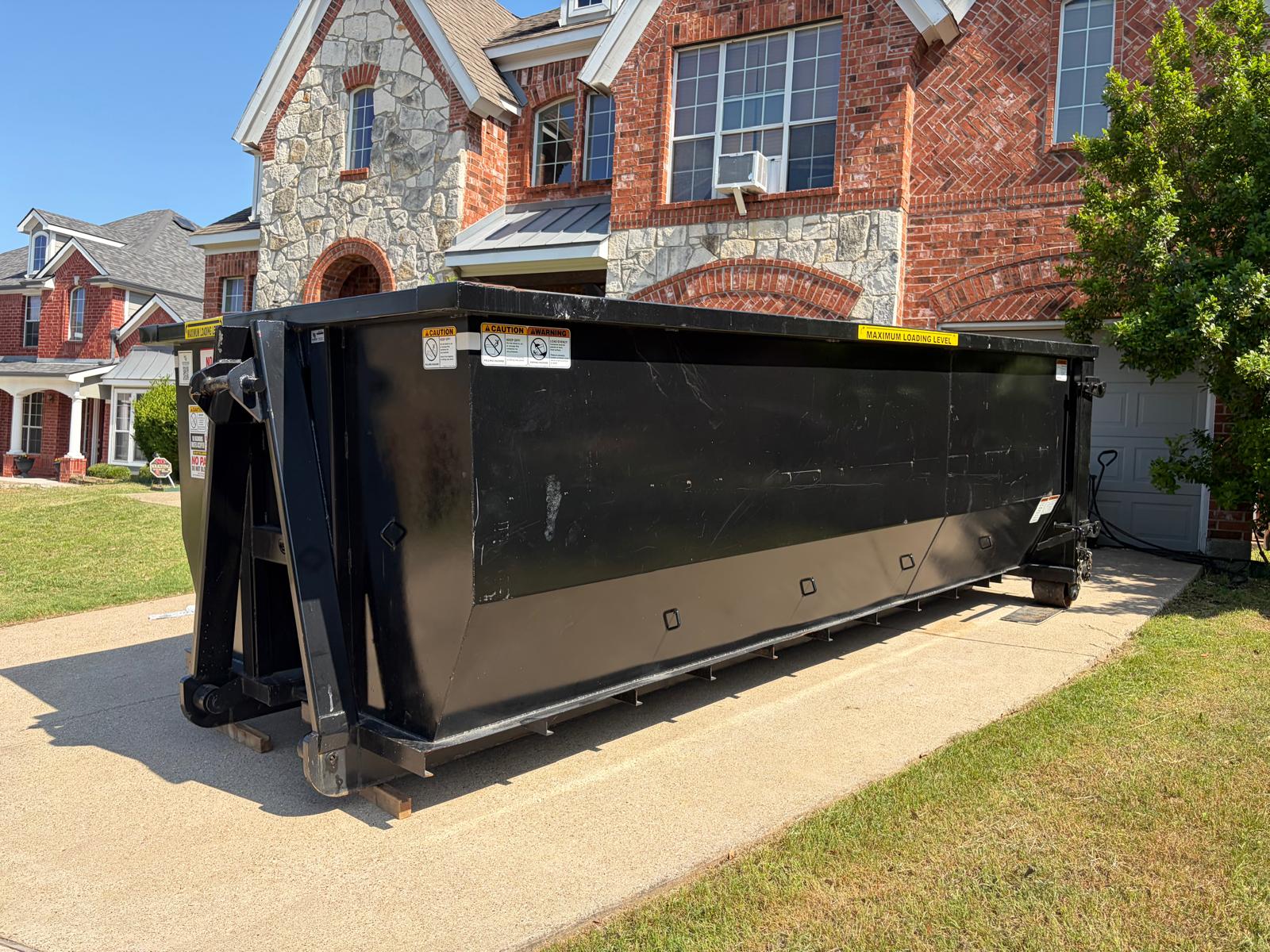 Lone Wolf Dumpsters roll-off truck delivering dumpster in Dallas-Fort Worth area