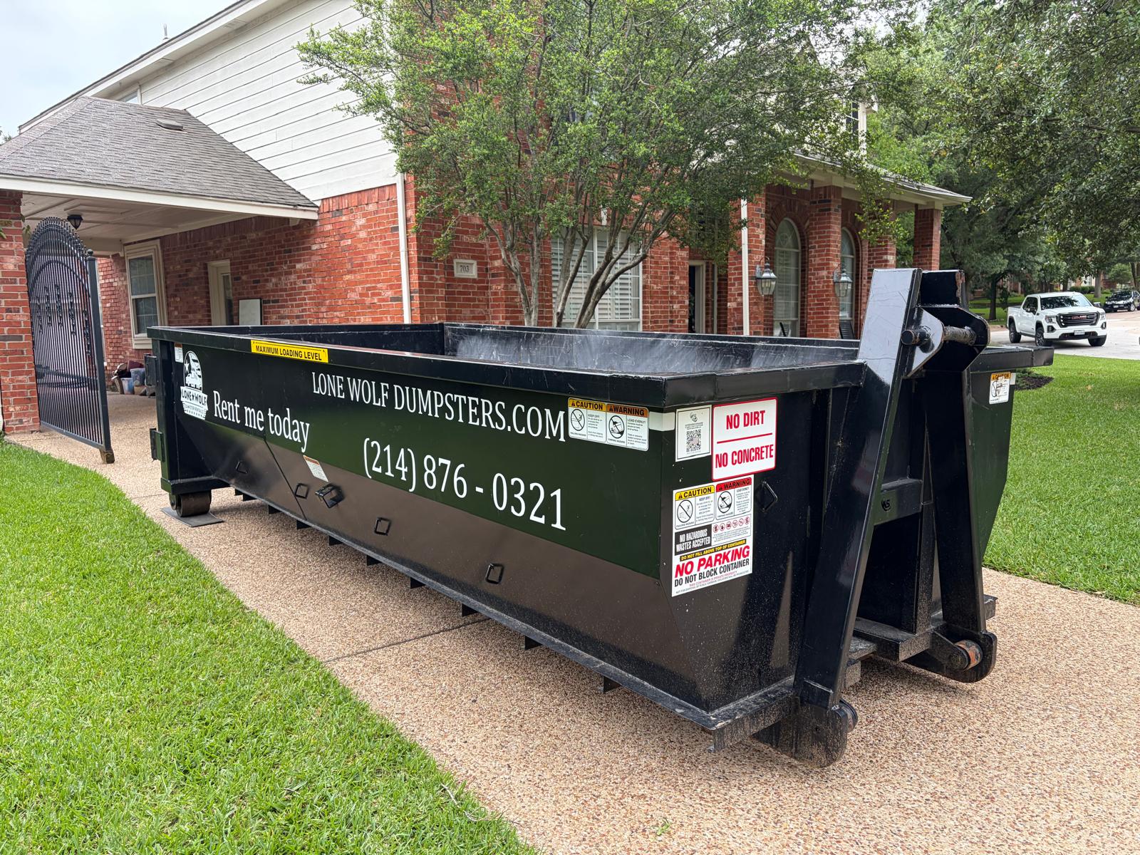 15 yard roll-off dumpster rental on a residential driveway in Dallas-Fort Worth