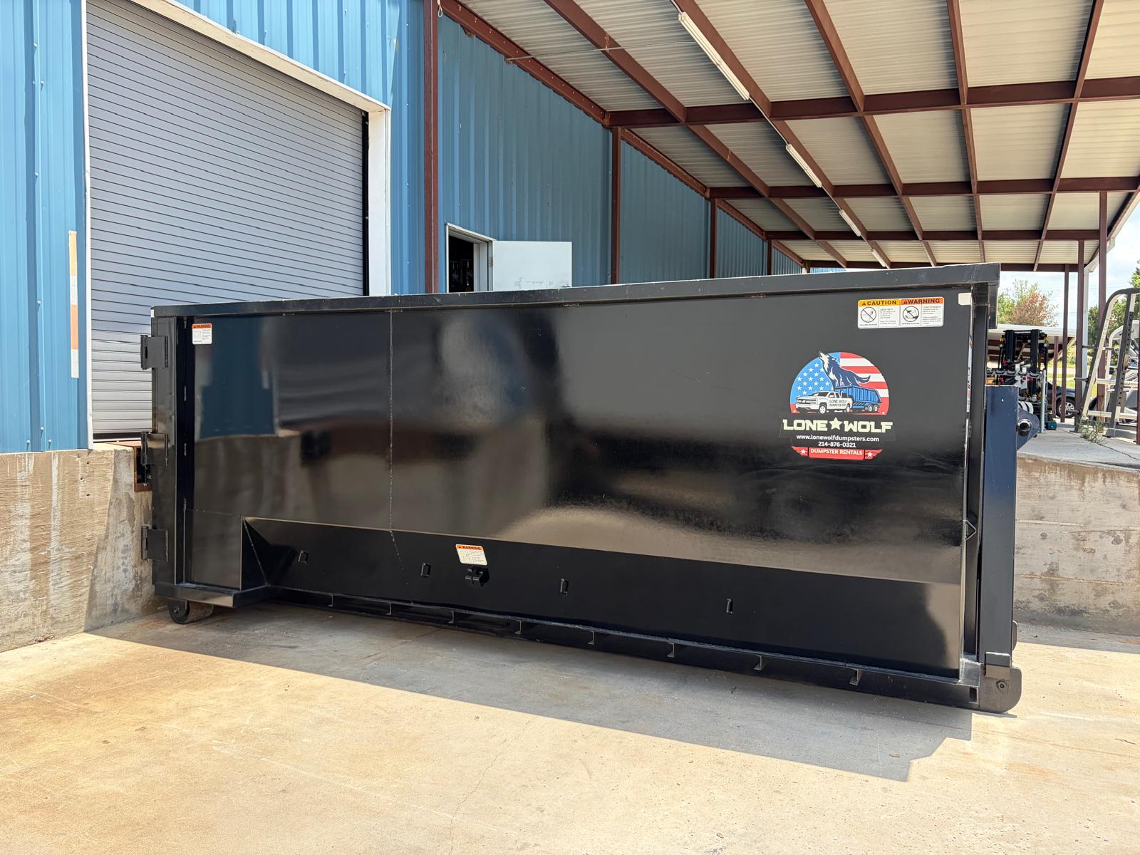 Commercial roll-off dumpster full of debris at a business job site in Dallas-Fort Worth